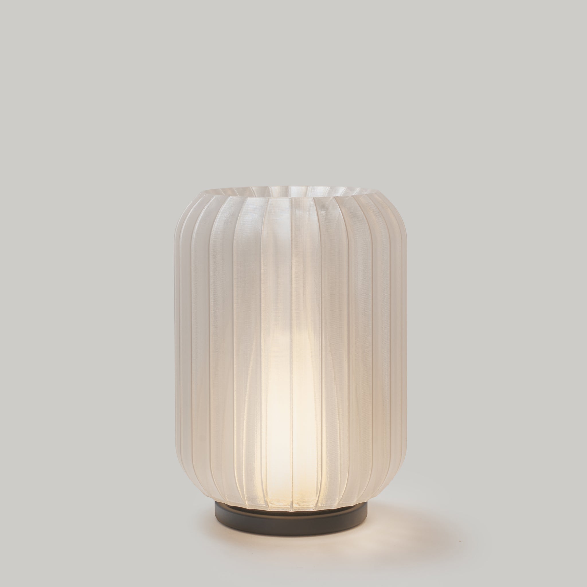 Decorative lamp with ribbed design on a light gray background