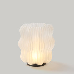 Decorative lamp with ribbed design on a gray background