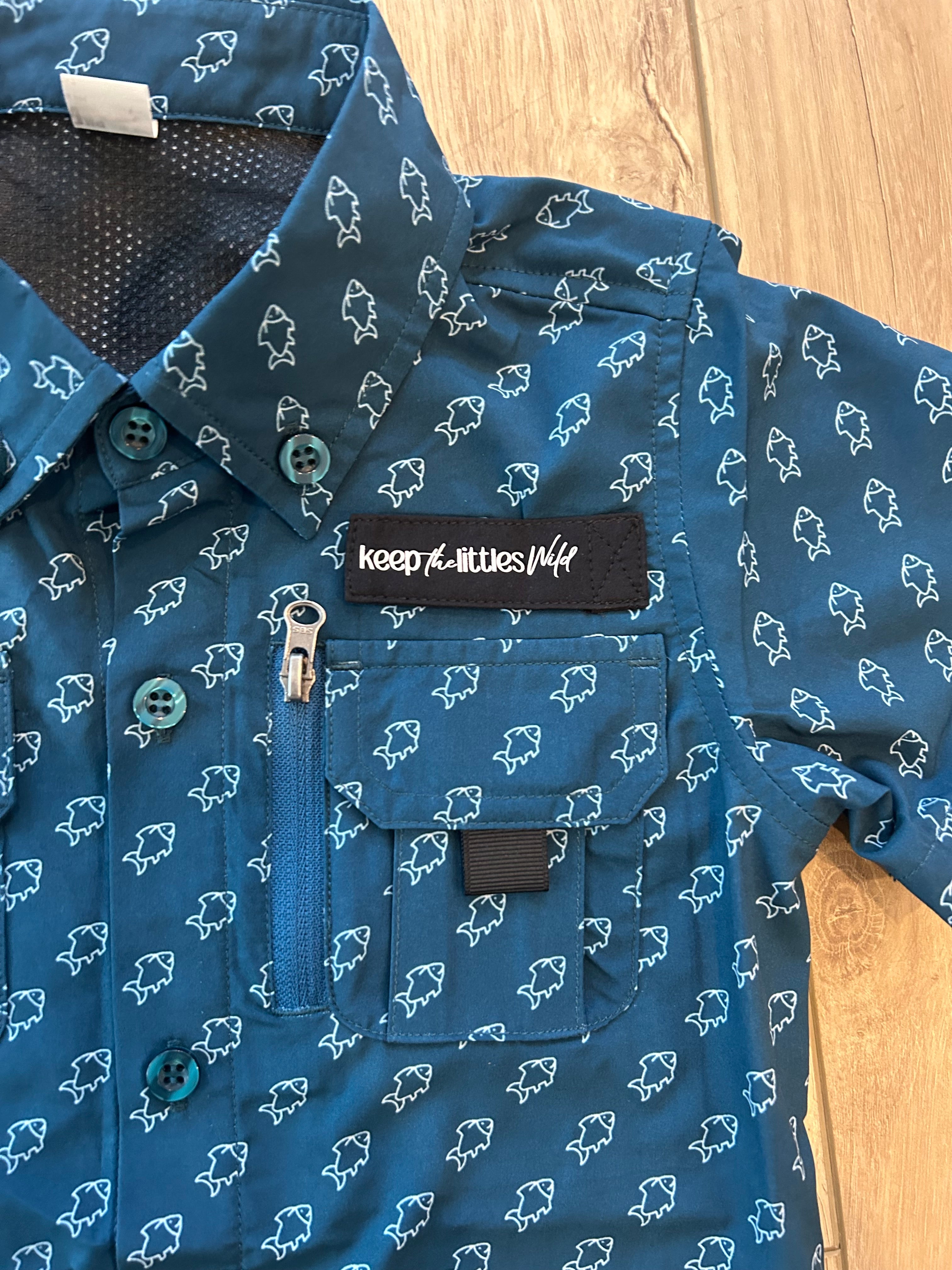 Blue shirt with white patterns on a wooden surface