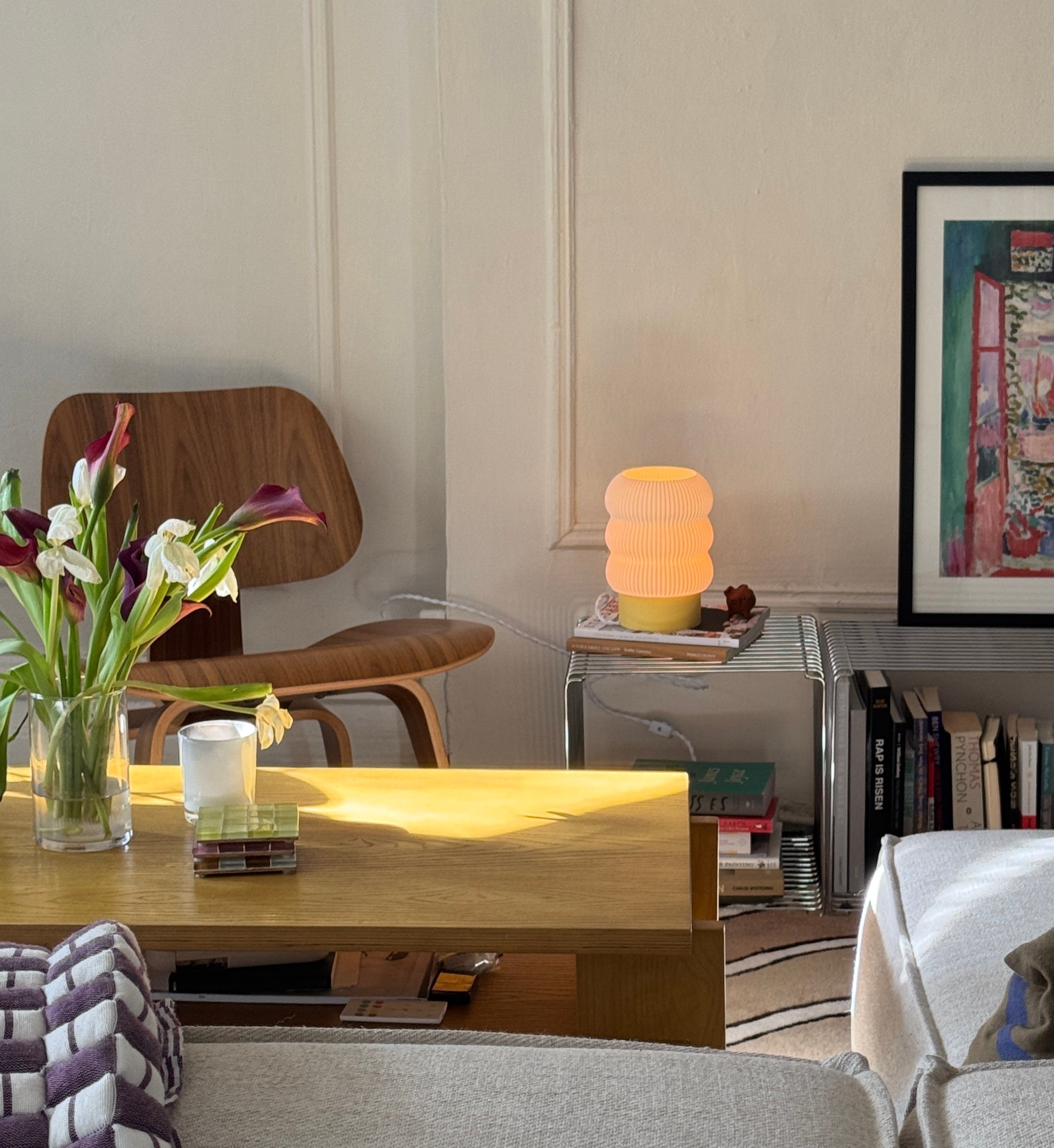 Living room with a wooden table, chair, and decorative items.