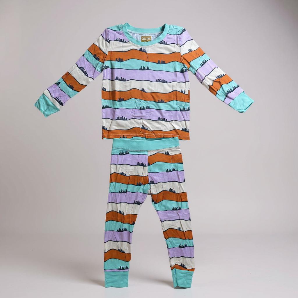 Children's pajama set with colorful striped pattern on a gray background