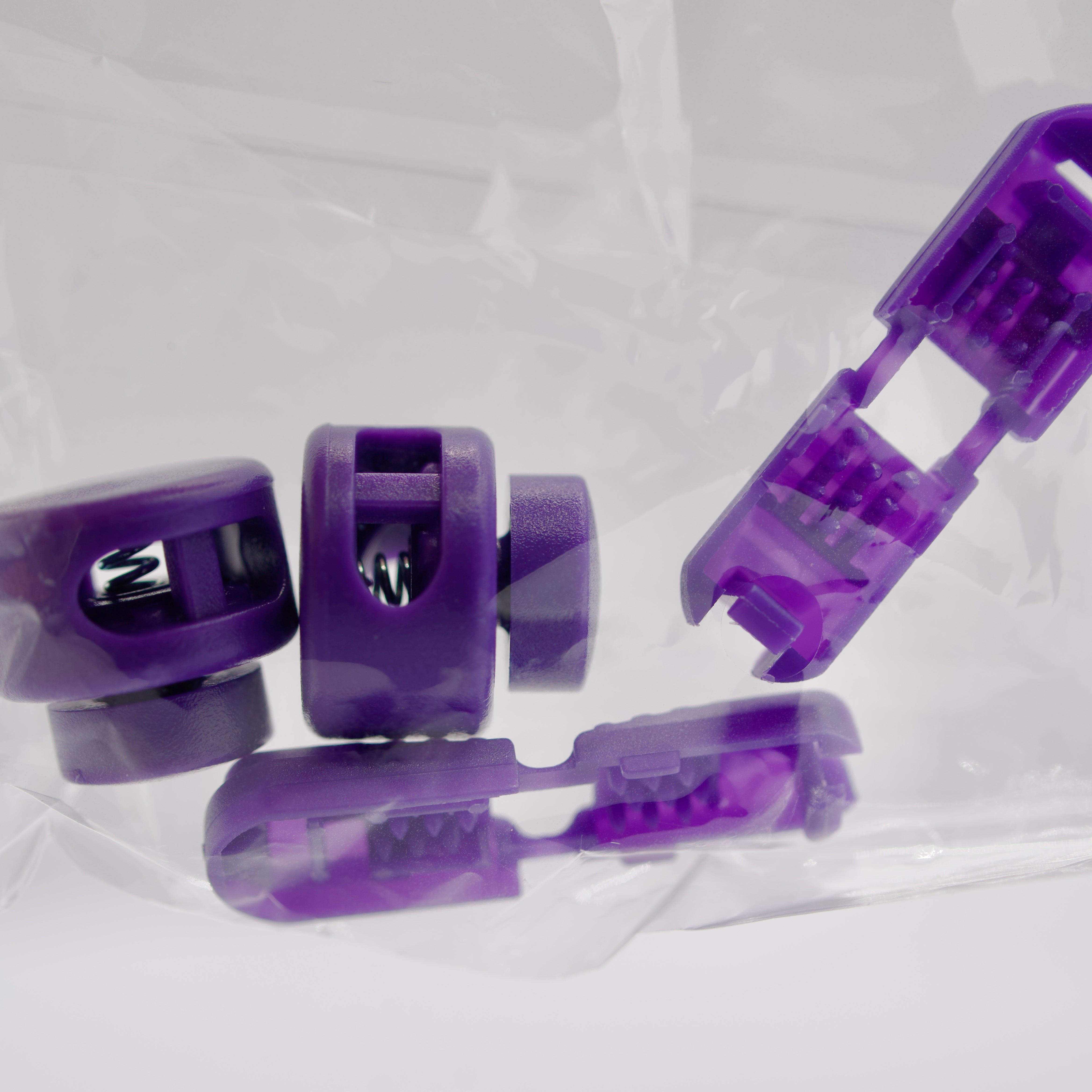 Purple plastic components on a clear background