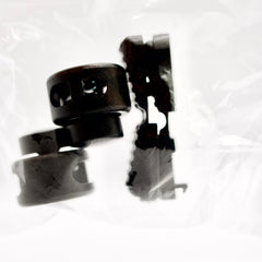 Black plastic components on a white background
