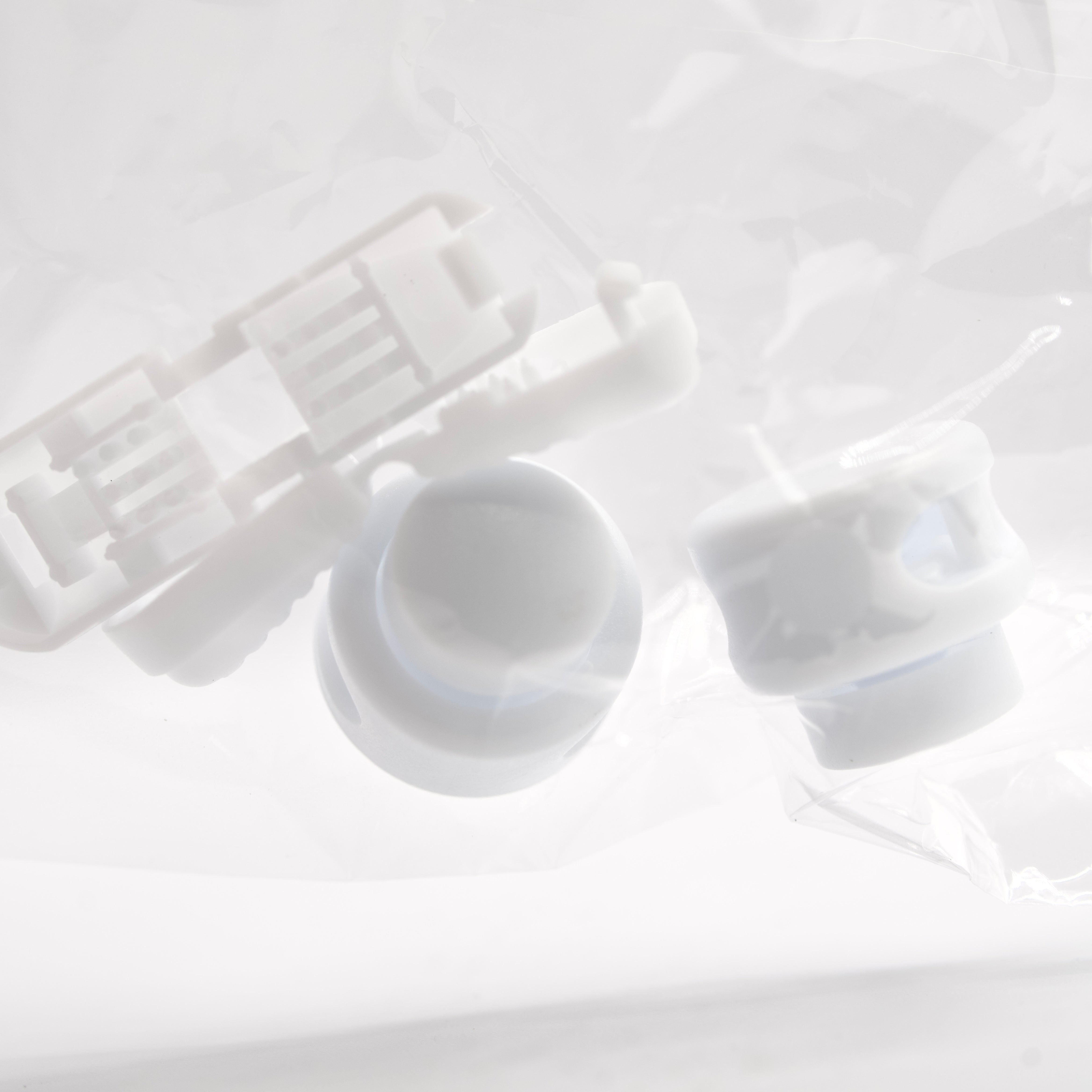 White plastic components on a light gray background