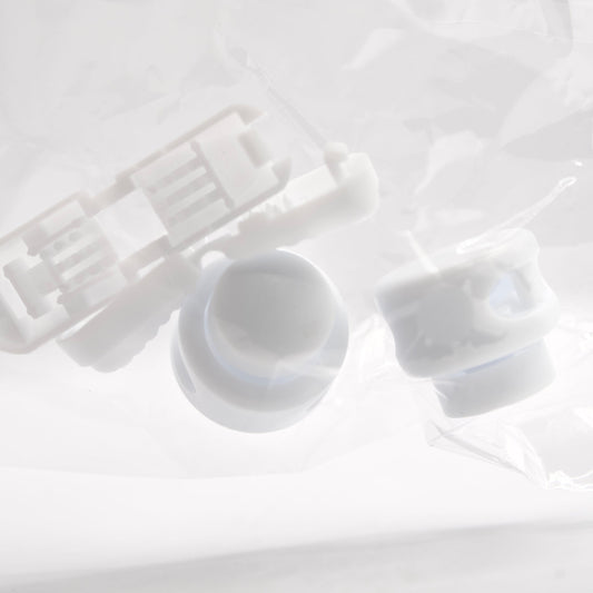 White plastic components on a light gray background