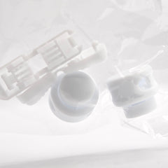 White plastic components on a light gray background