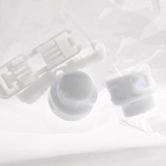 White plastic components on a light gray background