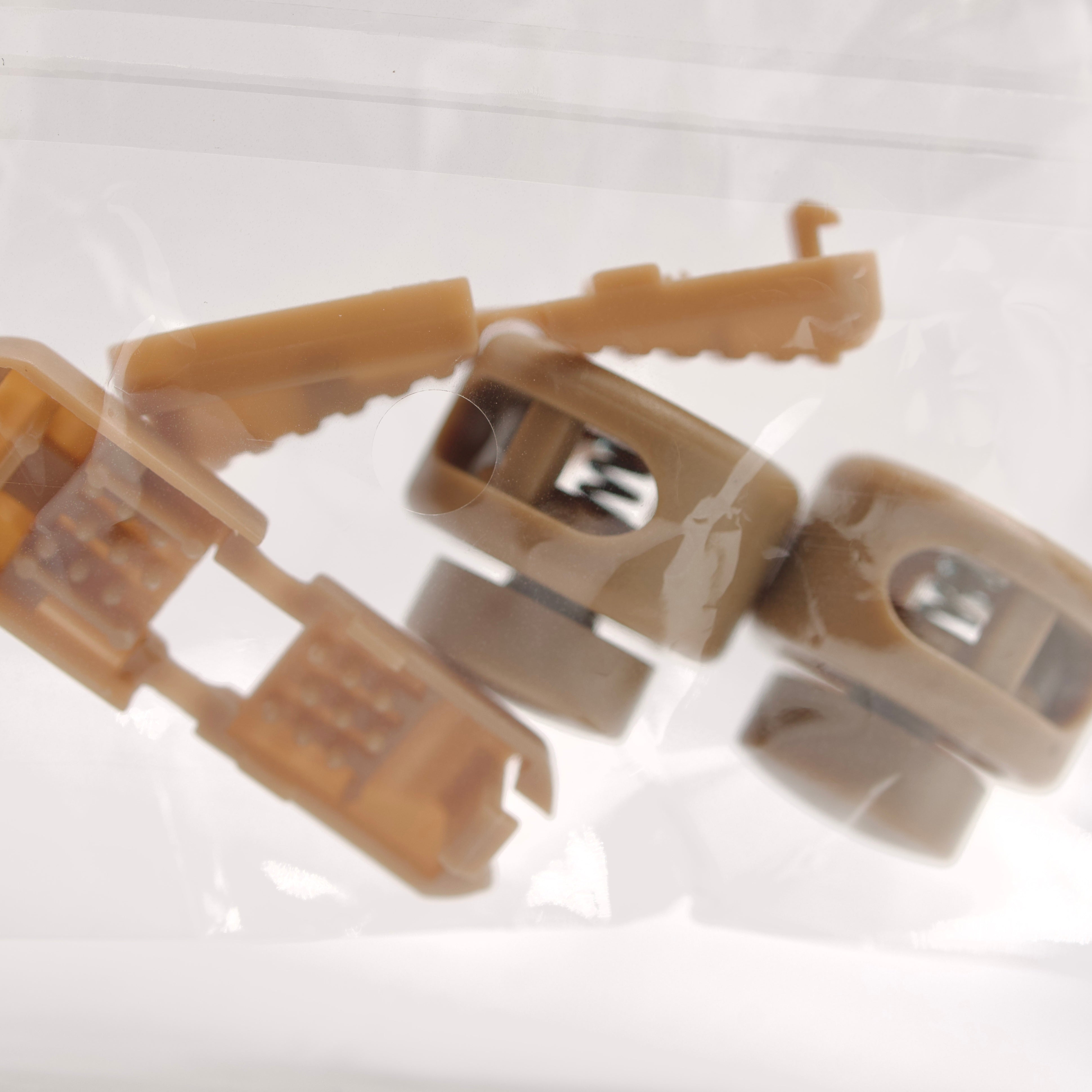 Close-up of brown plastic clips on a white background