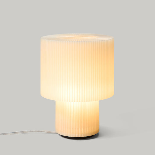 Table lamp with ribbed design on a gray background