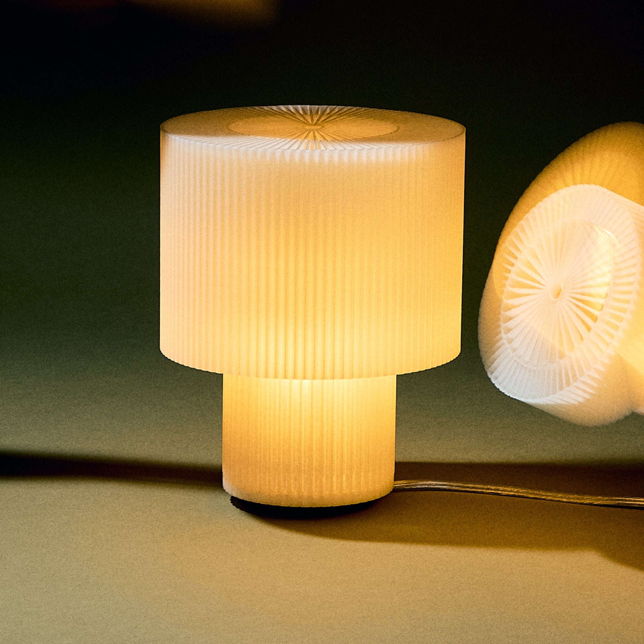 Decorative lamp with ribbed design on a dark background