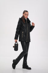 Woman wearing a black leather jacket and pants on a white background