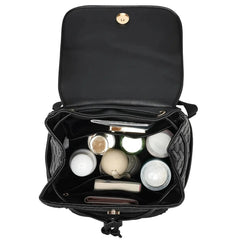Black makeup bag with cosmetic items on a white background