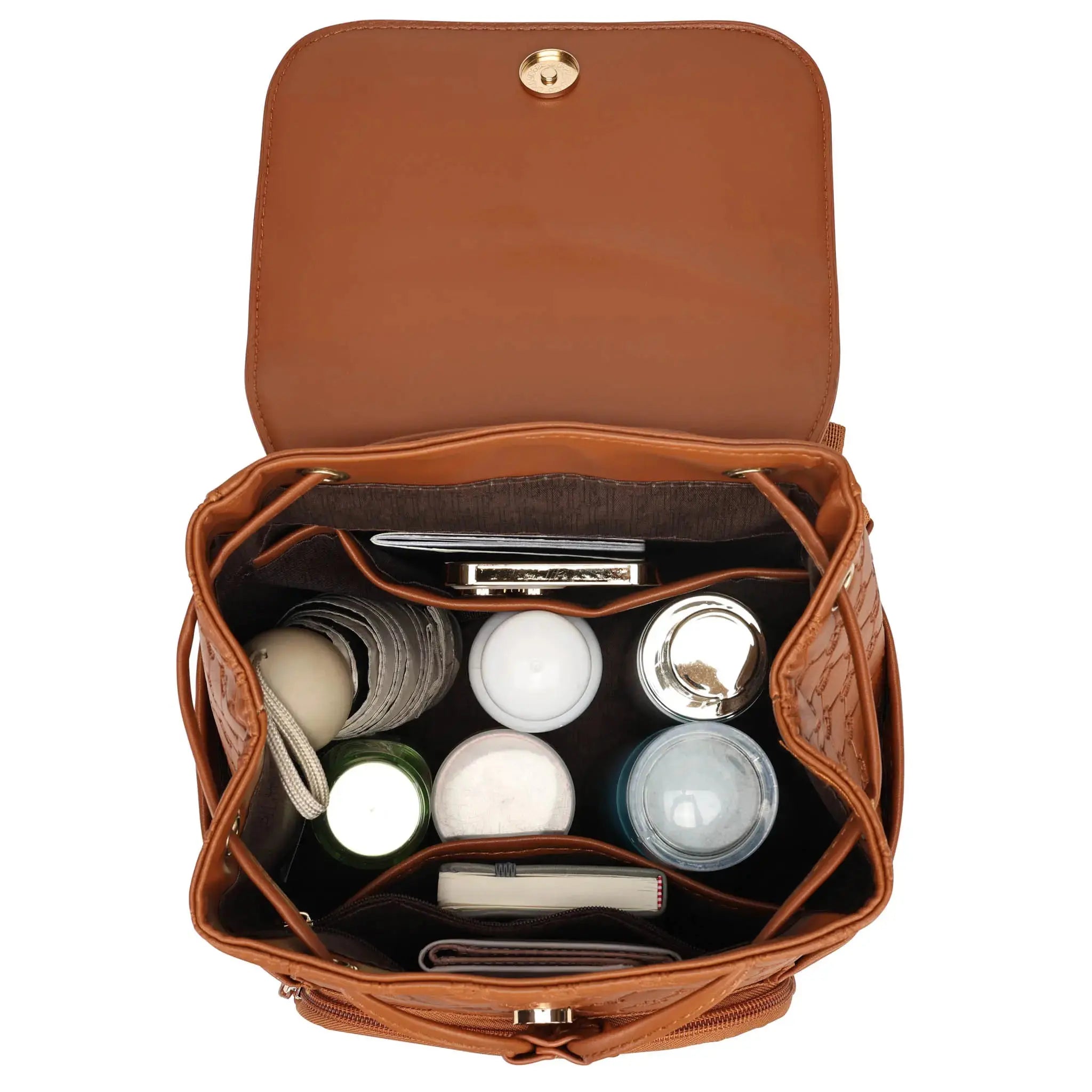 Brown leather bag with cosmetic items on a white background