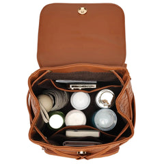 Brown leather bag with cosmetic items on a white background
