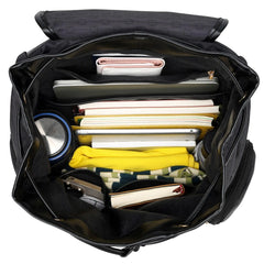 Black backpack with compartments filled with various items on a white background