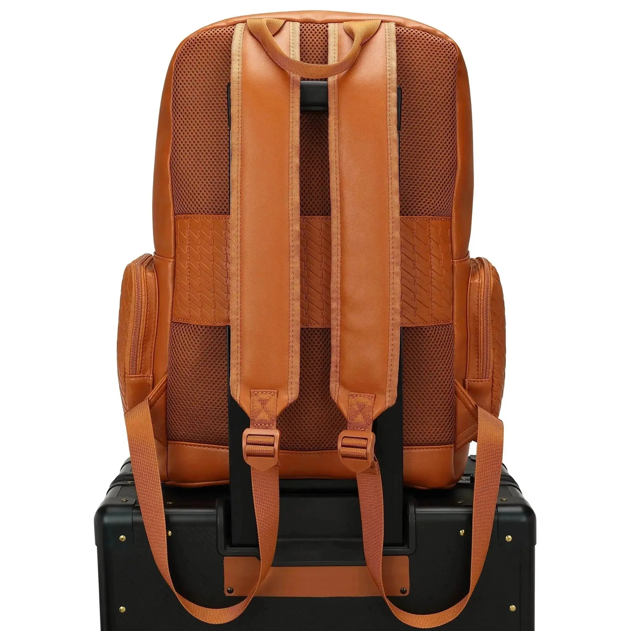 Brown leather backpack on a black suitcase with a white background