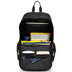 Black backpack with compartments and items on a white background