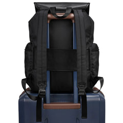 Black backpack with straps on a blue suitcase against a white background