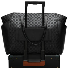 Black patterned suitcase with handle and wheels on a white background