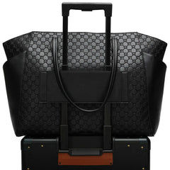 Black patterned suitcase with a matching handbag on a white background