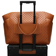 Brown textured tote bag with black handle and strap on a white background