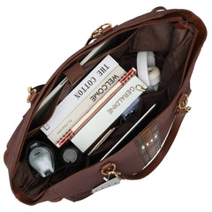 Brown leather bag with items including books and a bottle inside