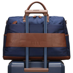 Blue suitcase with brown accents and 'ELLE' branding on a white background