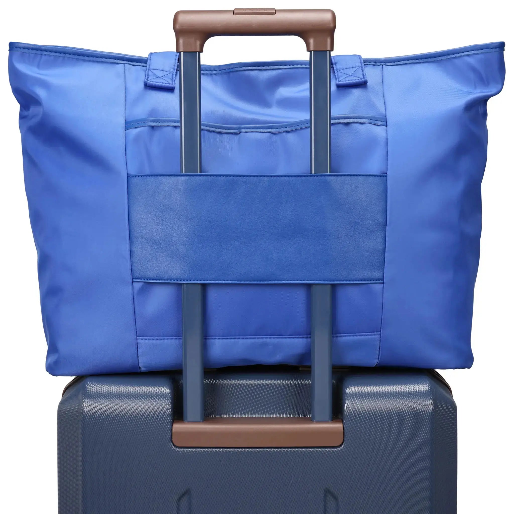 Blue bag with brown handle on top of a blue suitcase with brown handle
