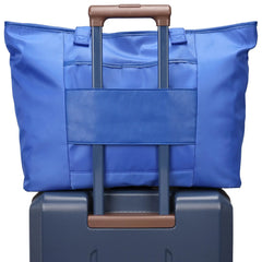 Blue bag with brown handle on top of a blue suitcase with brown handle