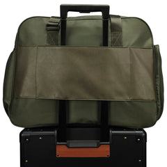 Green duffel bag on top of a black suitcase with a white background