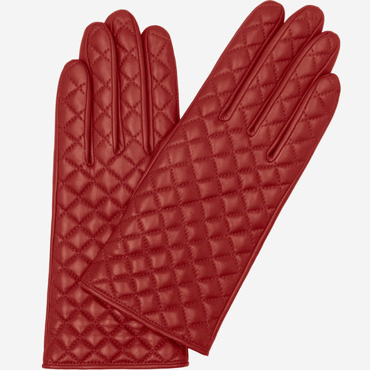 Pair of black quilted gloves on a white background