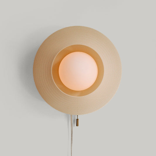 Wall-mounted lamp with a textured beige shade on a light gray background