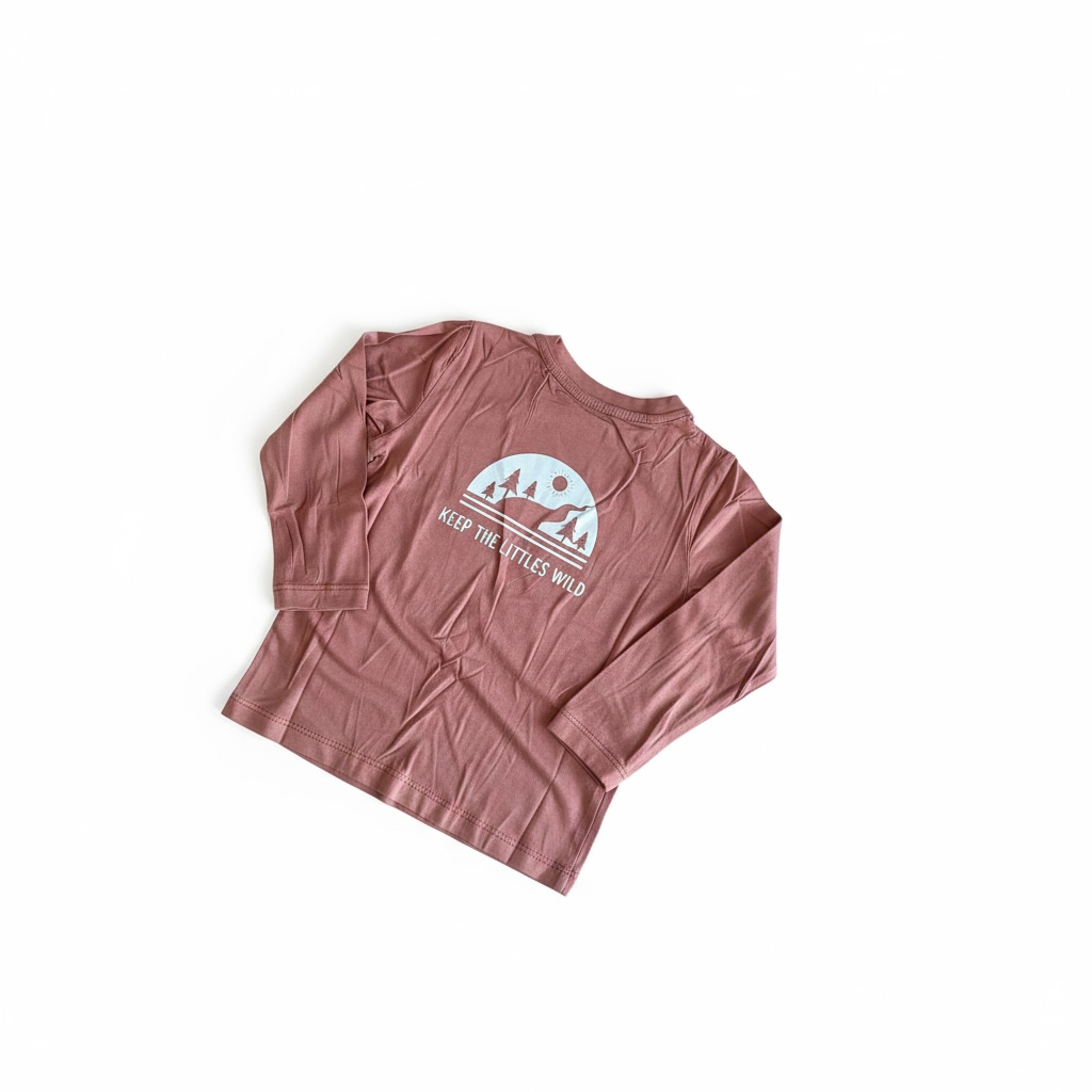 Pink long-sleeve shirt with a graphic design on a white background