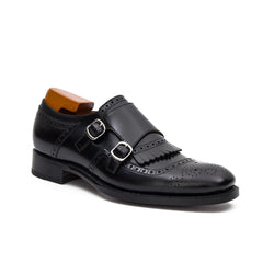 Black leather dress shoe with double buckle on a white background