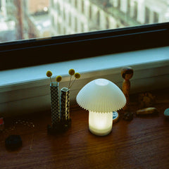Mushroom-shaped lamp on a windowsill with decorative items