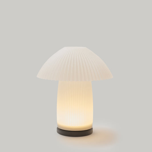 Mushroom-shaped table lamp with ribbed design on a gray background