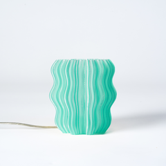 Green wavy-patterned lamp on a white background