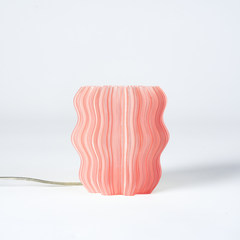 Pink wavy-patterned lamp on a white background