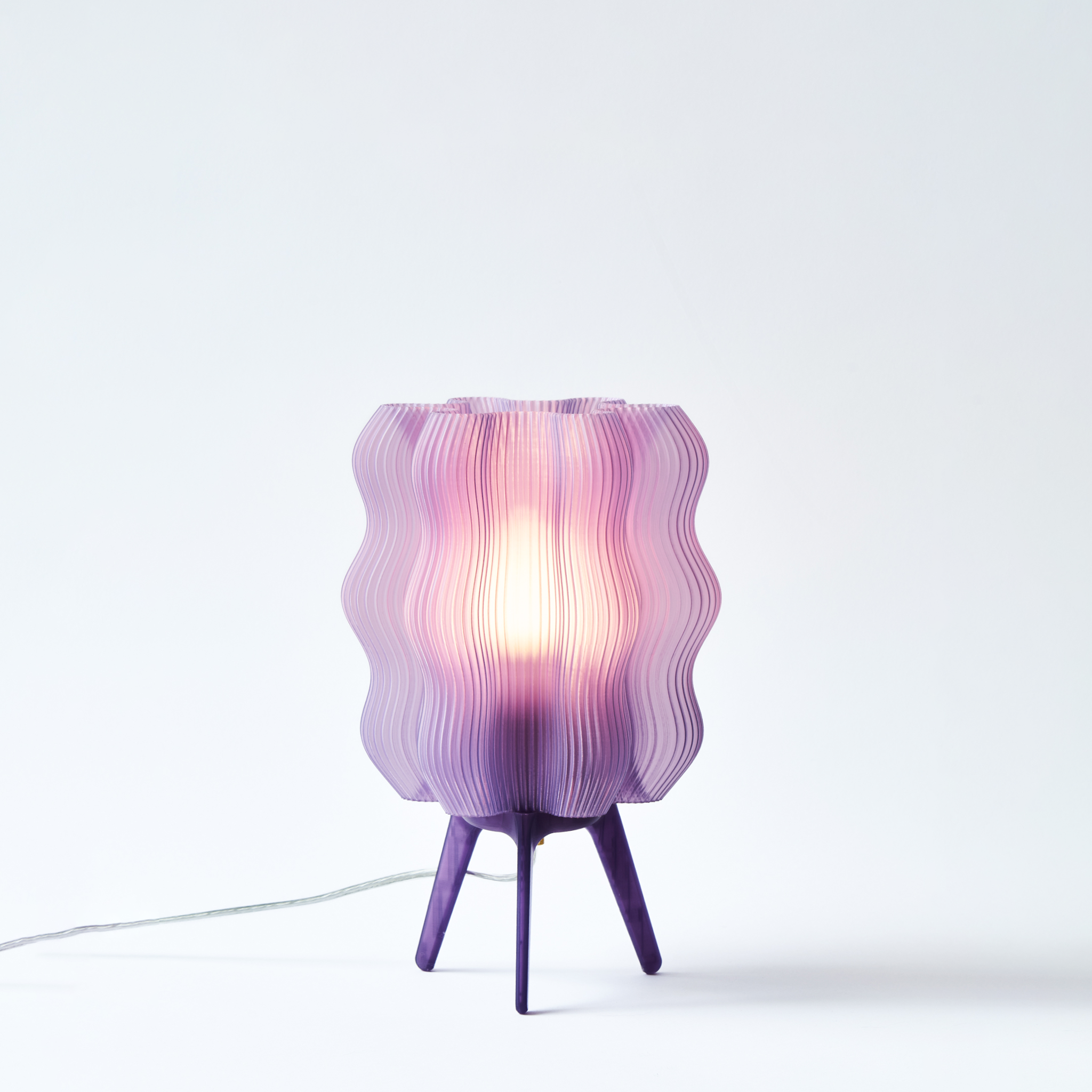 Purple textured table lamp on a white background