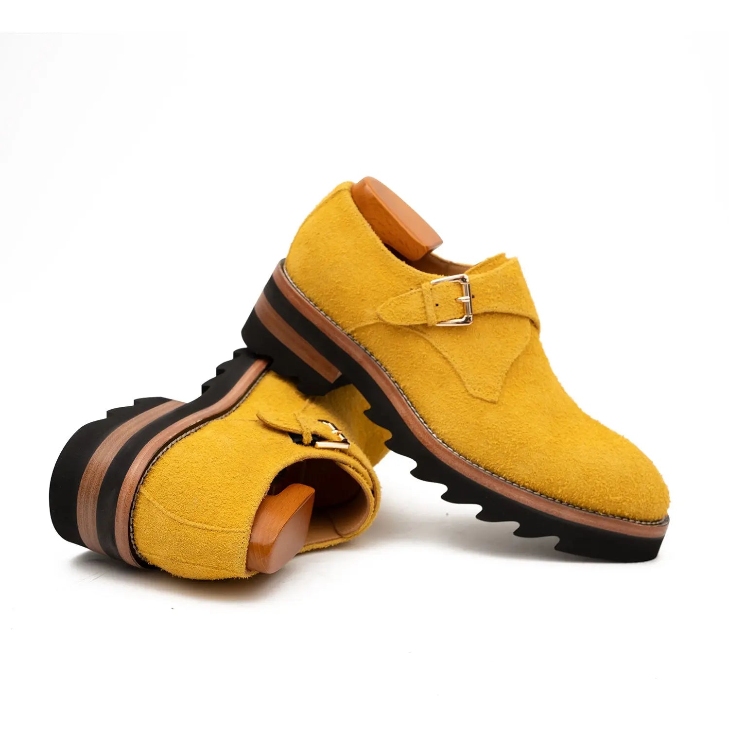 Yellow shoes with brown accents on a white background