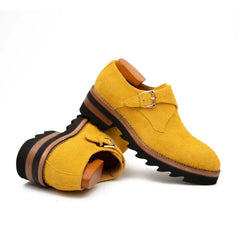 Yellow shoes with brown accents on a white background