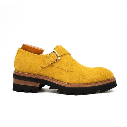 Yellow suede shoe with a brown sole on a white background