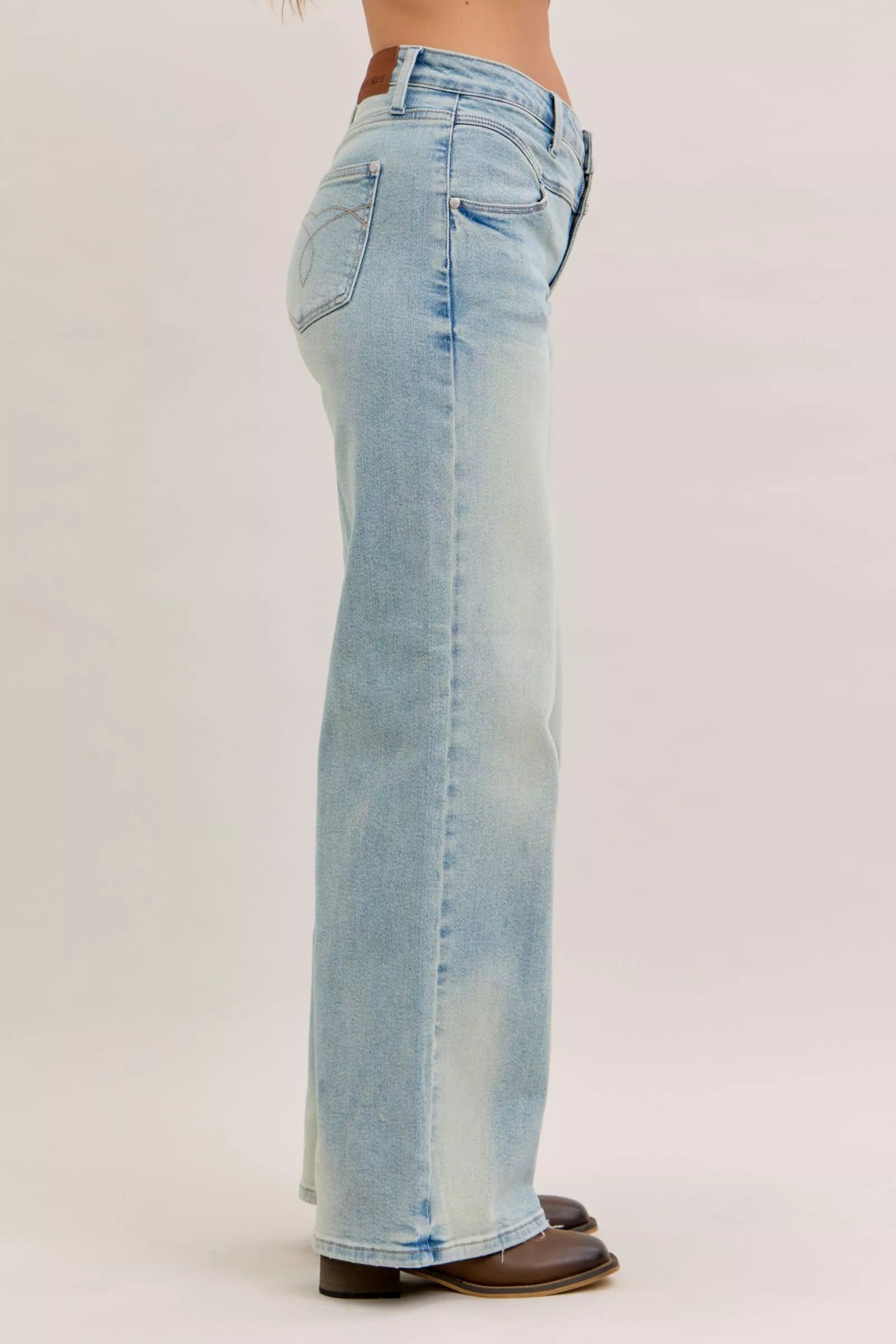 Light blue jeans worn by a person on a white background