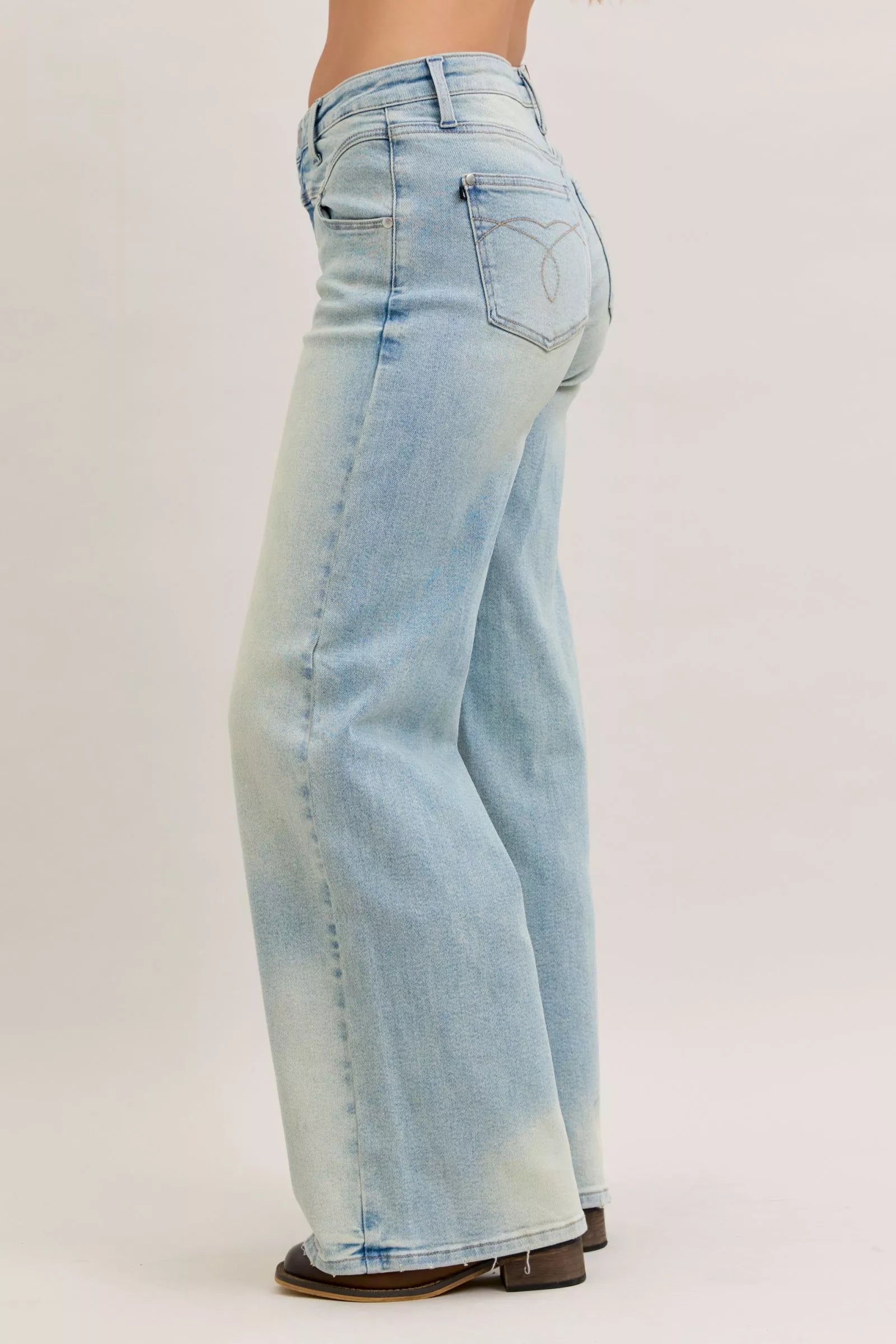 Light blue jeans worn by a person on a white background