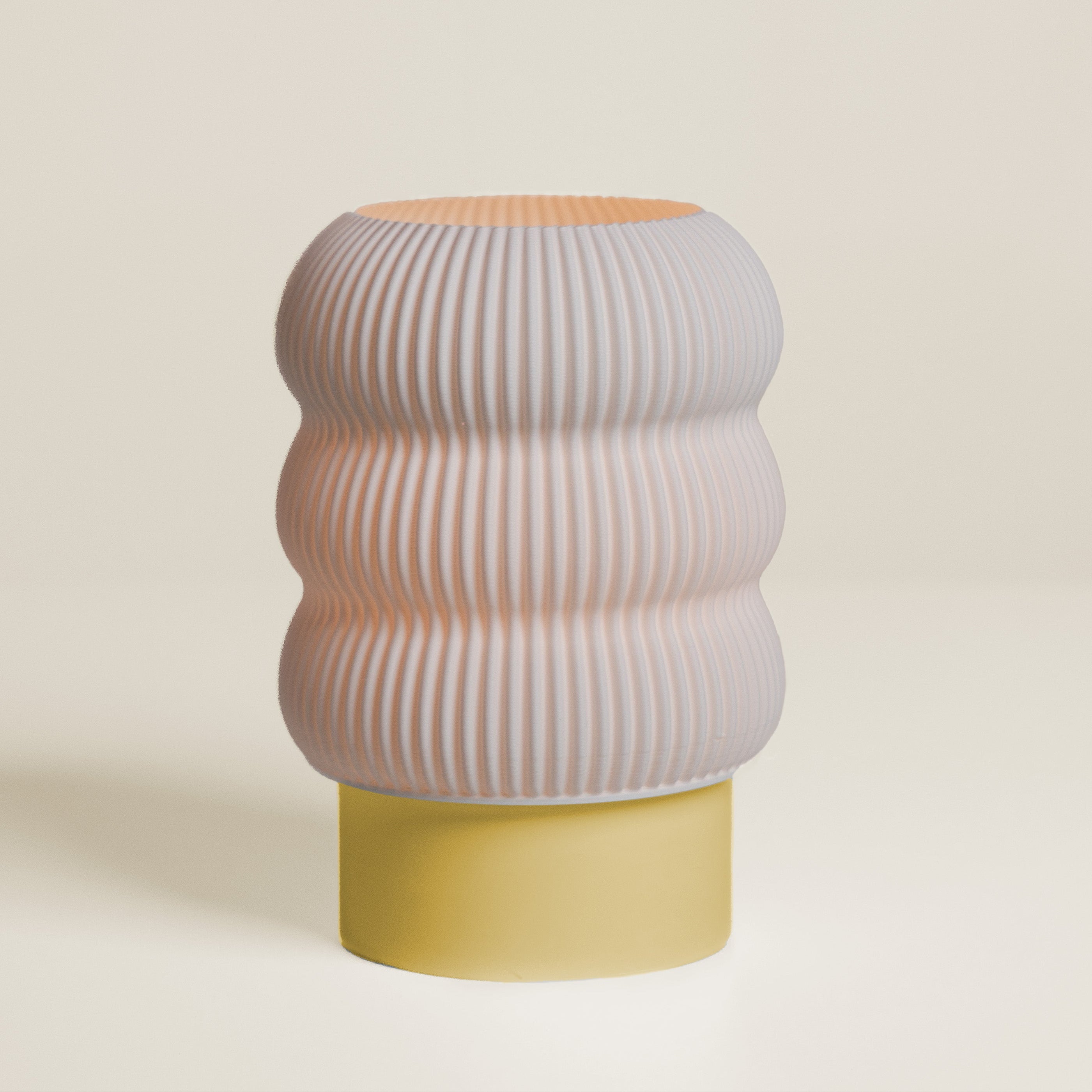 Stool with ribbed design and two-tone color on a beige background