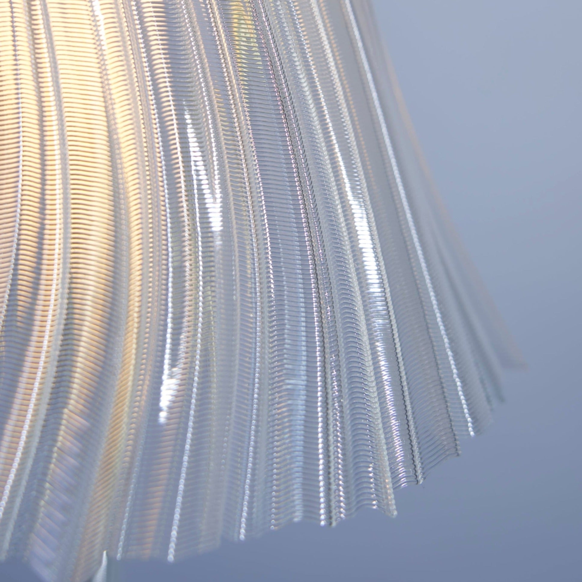 Metallic pleated fabric against a blue sky