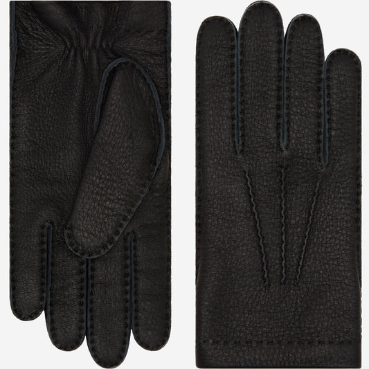 Pair of black gloves with textured surface on a white background