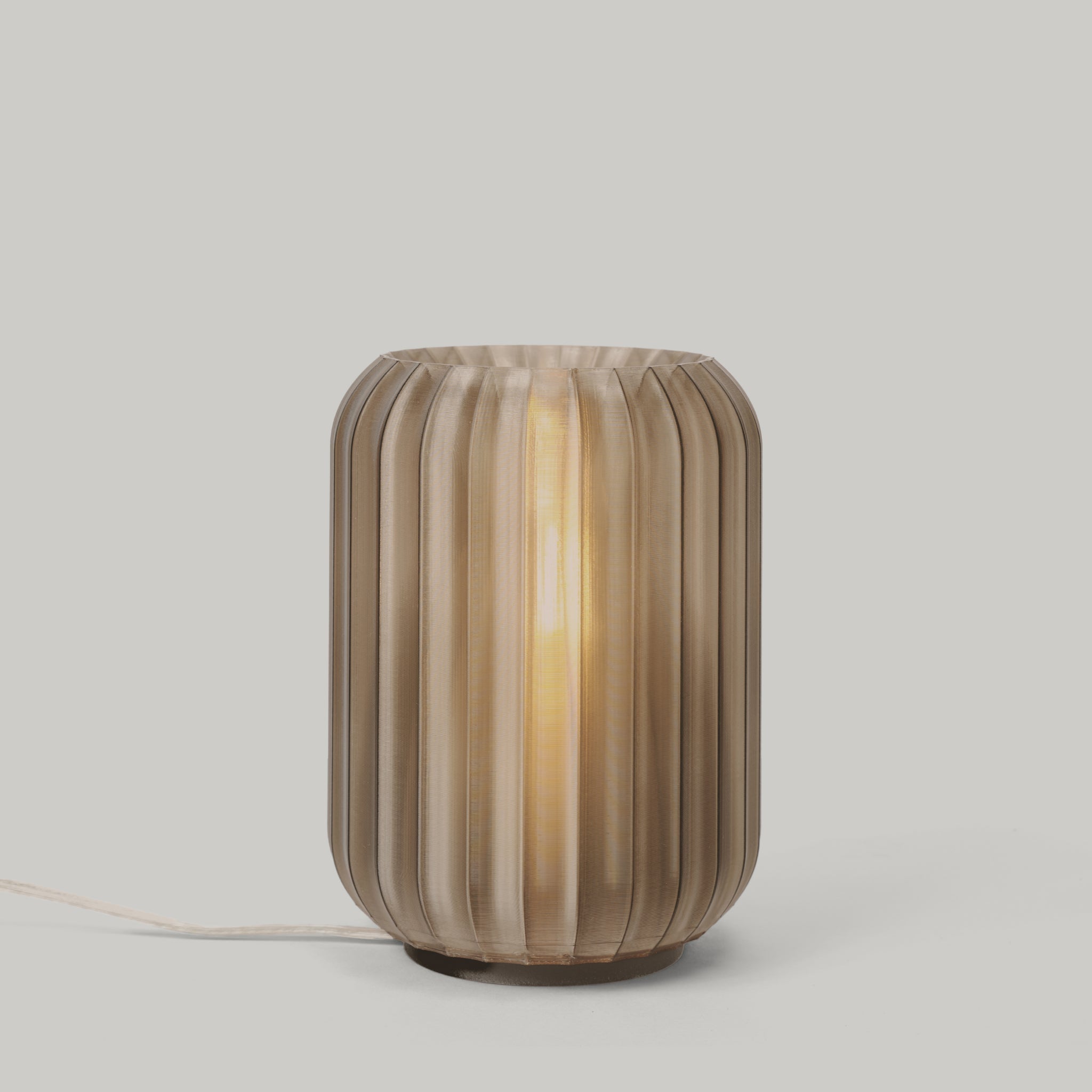 Decorative lamp with striped design on a neutral background