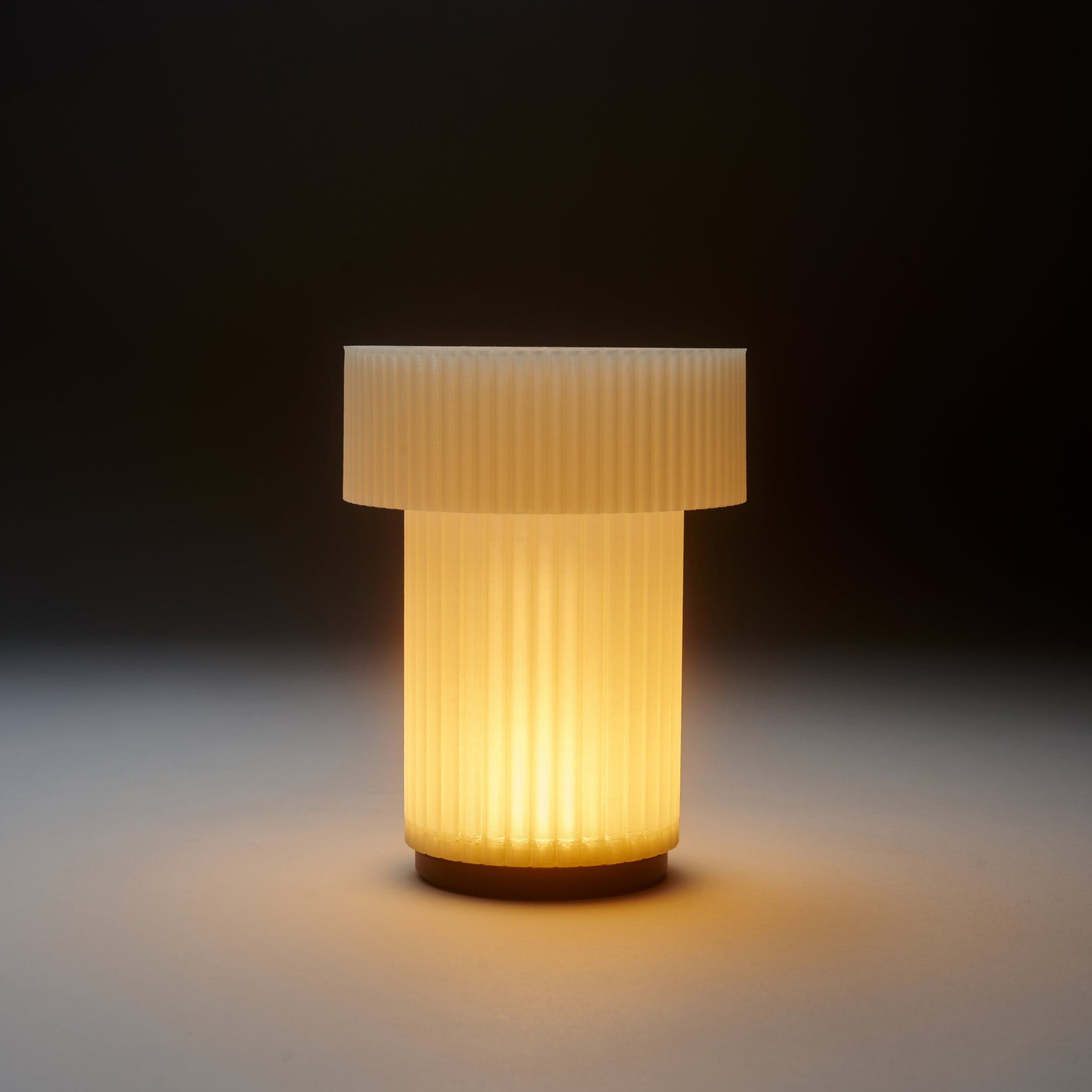 Decorative lamp with ribbed design on a dark background