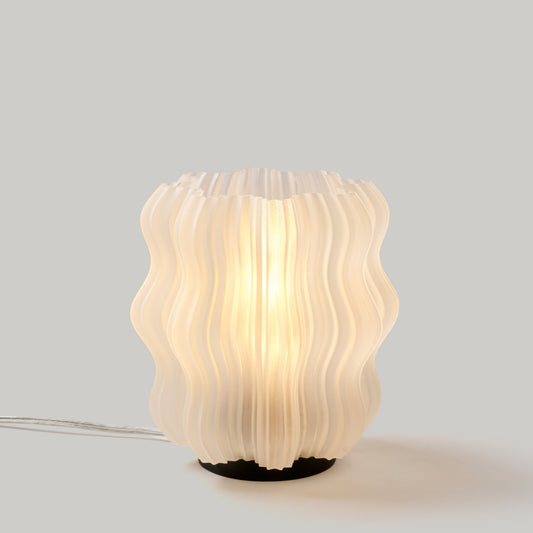 Wavy-textured table lamp on a light gray background